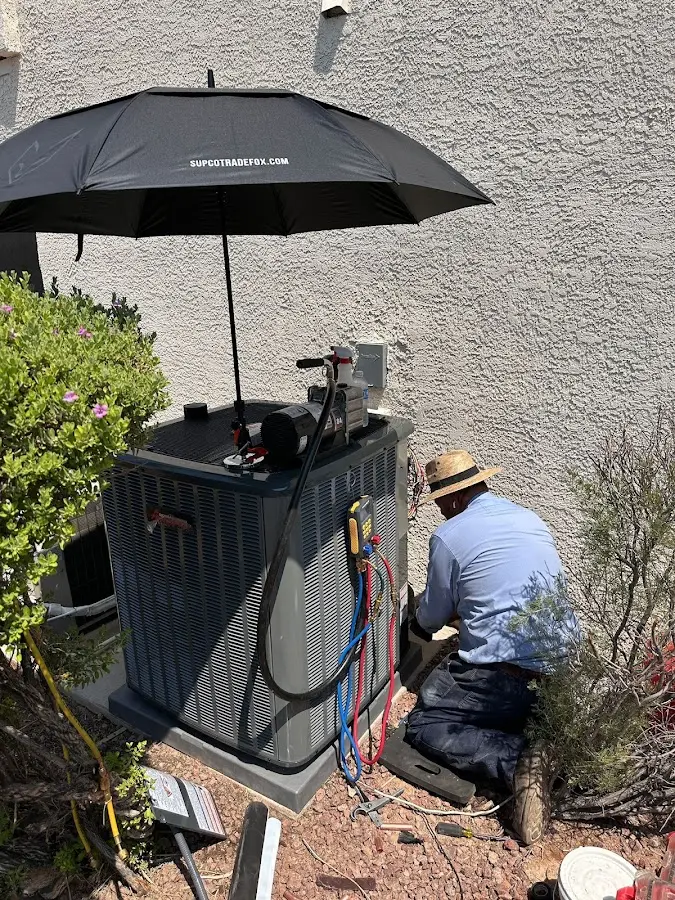 HVAC technician performing outdoor AC maintenance in Columbus